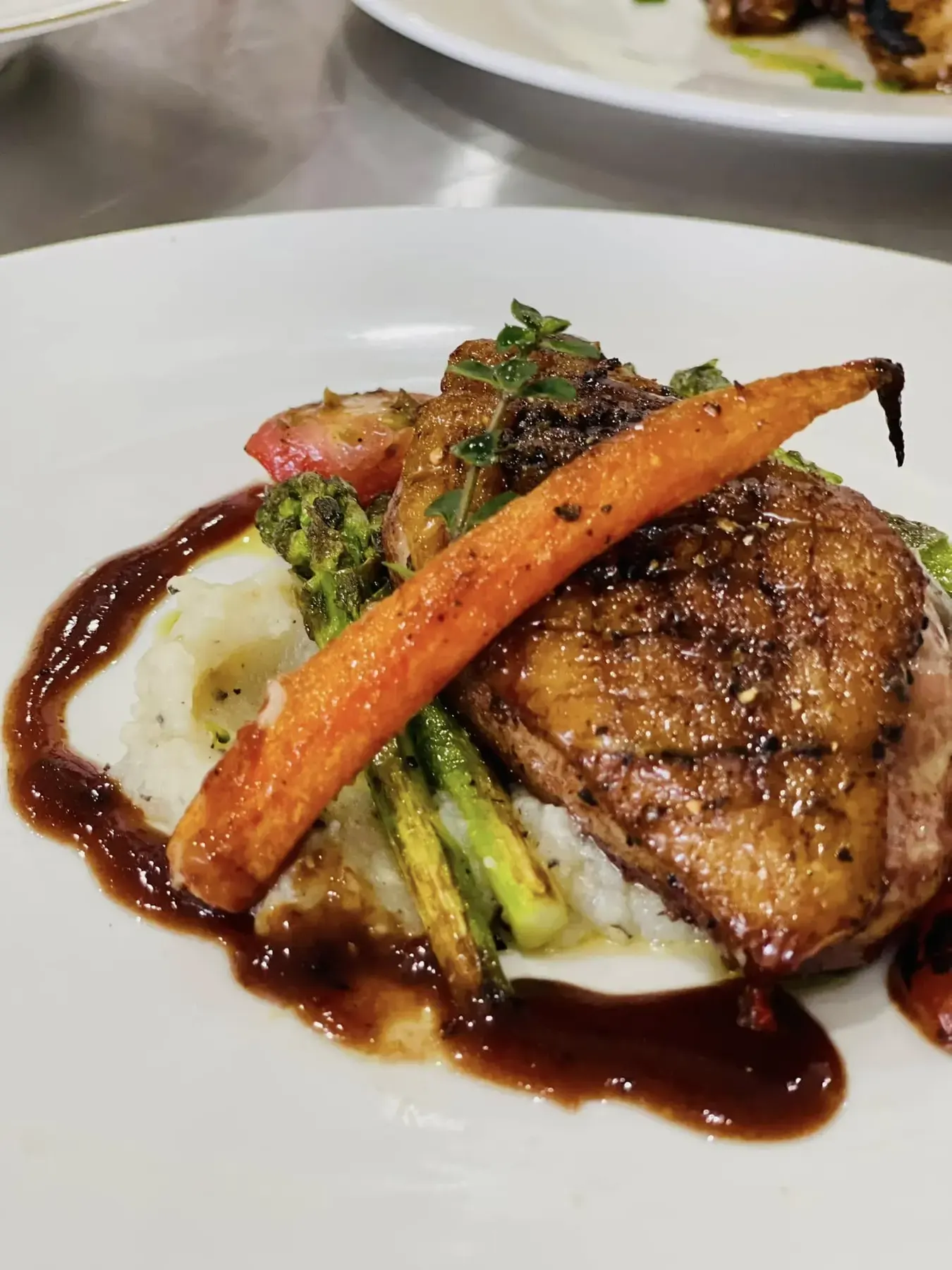 Seared duck with mash, asparagus and glazed carrot
